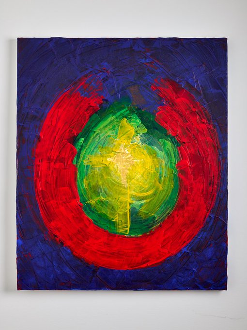 A vibrant abstract painting with concentric circles of red, green, and yellow on a deep blue textured background.
