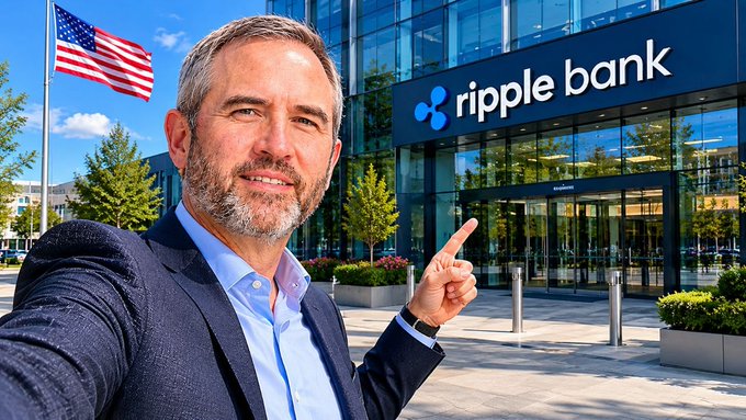 The image features a man dressed in a suit standing outside of Ripple Bank building. He is pointing at the bank's sign, which reads "Ripple Bank". The man appears to be taking a photo or selfie with his phone. The background includes an American flag and some trees, suggesting that the location might be in the United States. The image also contains text that reads "Focus on what is in the image and how it relates to the post", which could possibly be a caption or description of the man's actions or surroundings.