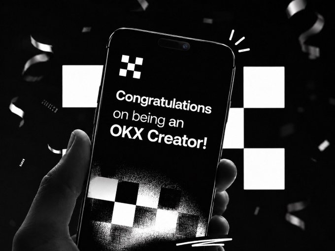 A black and white promotional image showing a hand holding a smartphone displaying 'Congratulations on being an OKX Creator!' with confetti and the OKX checkered logo in the background.