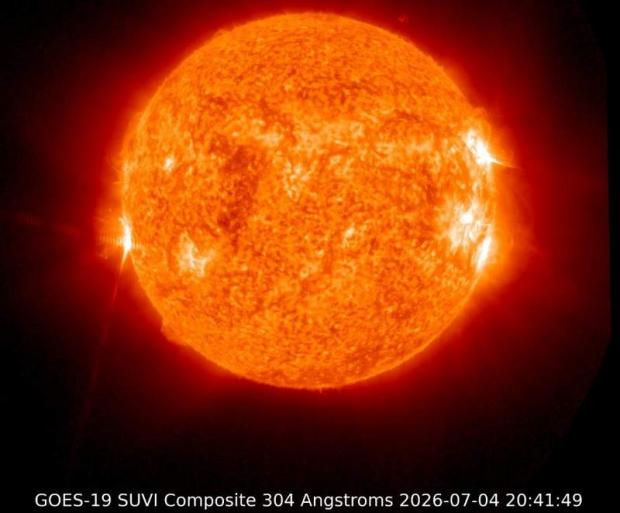 GOES-19 SUVI Composite 304 Angstroms image of the Sun dated 2026-07-04 20:41:49, showing a bright orange/red solar disk with active regions and flares.