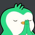 Duolingo-style owl mascot with closed eyes and green feathers holding its wings together in a prayer or sleeping pose.