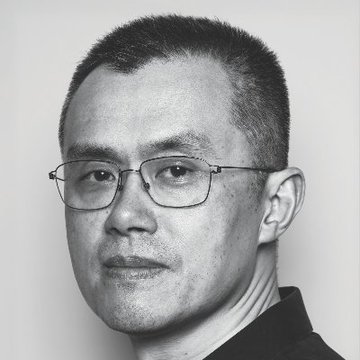 A black and white portrait shows a man with short dark hair wearing glasses.