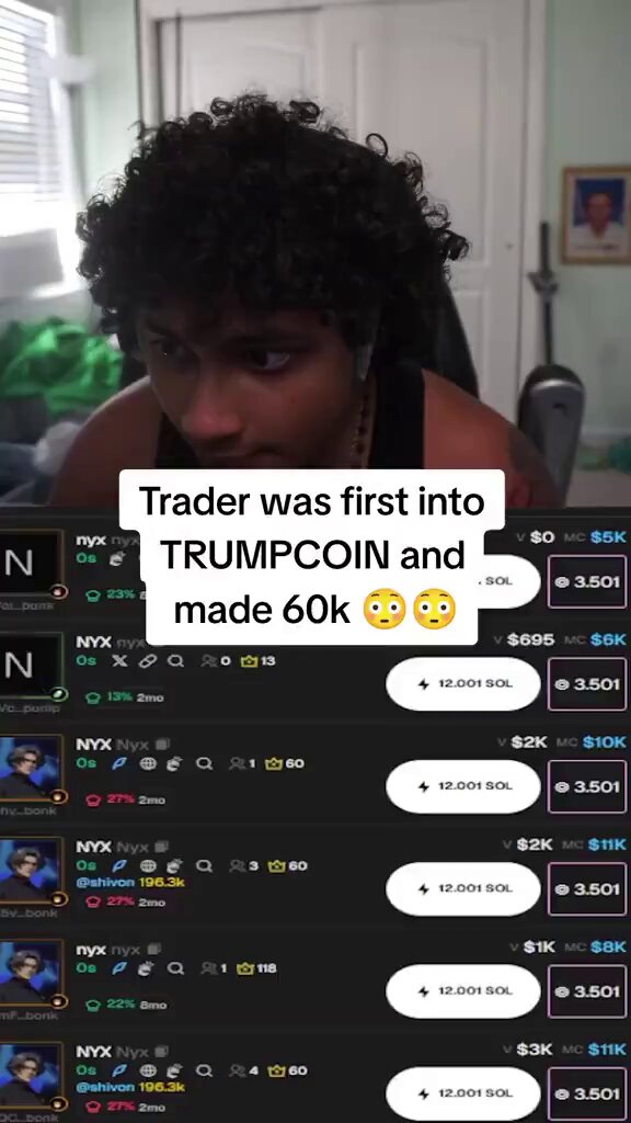 The image shows a man with curly hair wearing black clothing typing on a keyboard or possibly using a controller while holding a video game remote control, with a sign below him that says "Trader was first into Trumpcoin and made 60,000". The surrounding objects are a keyboard, a video game remote control, and a green bag. The post appears to be discussing the creator of this content who has made money from trading and investing in Trump Coin, which is now worth over $60,000.