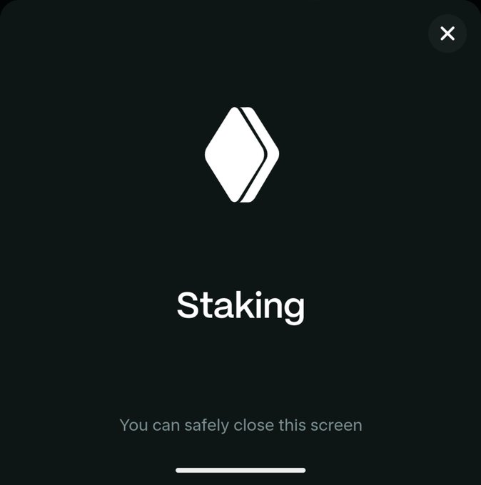 A digital interface displays a white logo with the word "Staking" and the message "You can safely close this screen" on a dark background.