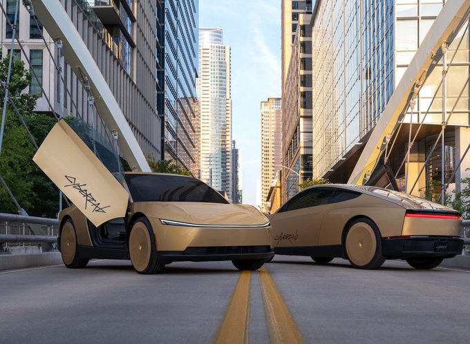 Two golden "Cybercab" prototype vehicles are parked facing each other on a city street, their falcon-wing doors open, aligning with the bullish sentiment toward $TSLA as Tesla pushes forward with its autonomous robotaxi vision.