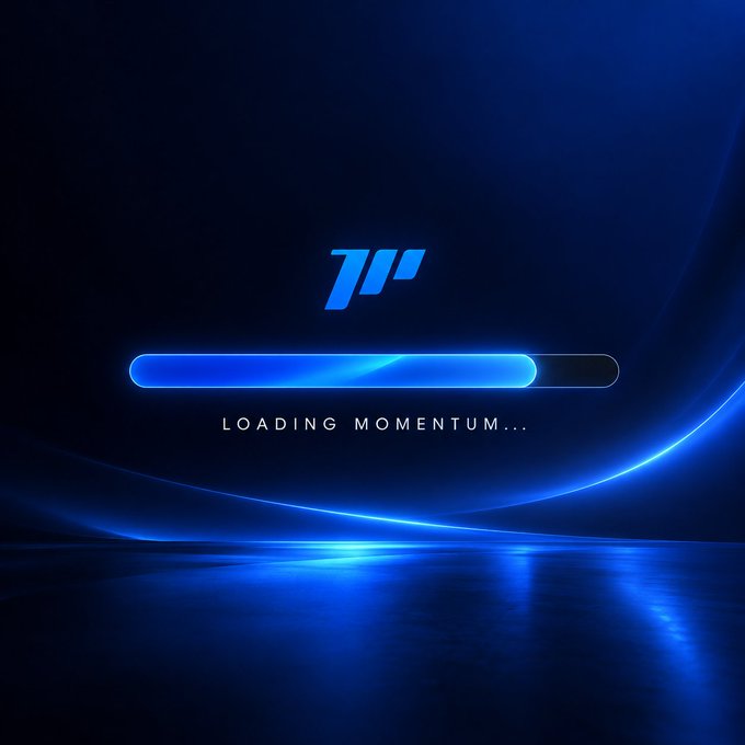 A dark blue futuristic loading screen displays a glowing progress bar at approximately 65% completion with the text "LOADING MOMENTUM..." beneath a stylized "1H" or arrow logo, visually representing the "GM" (Good Morning) post's request to keep the tab open while the day's trading momentum loads.