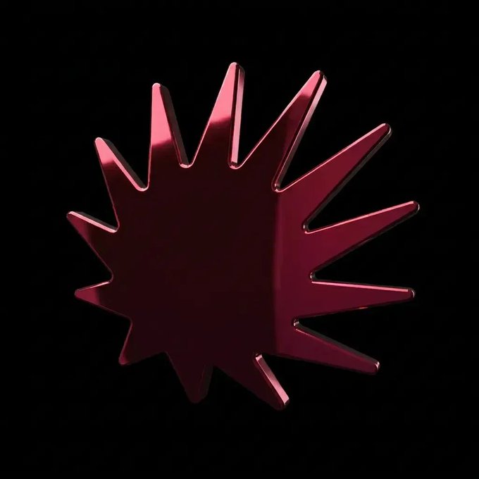 A metallic red 3D starburst or sun-like emblem rendered against a solid black background.