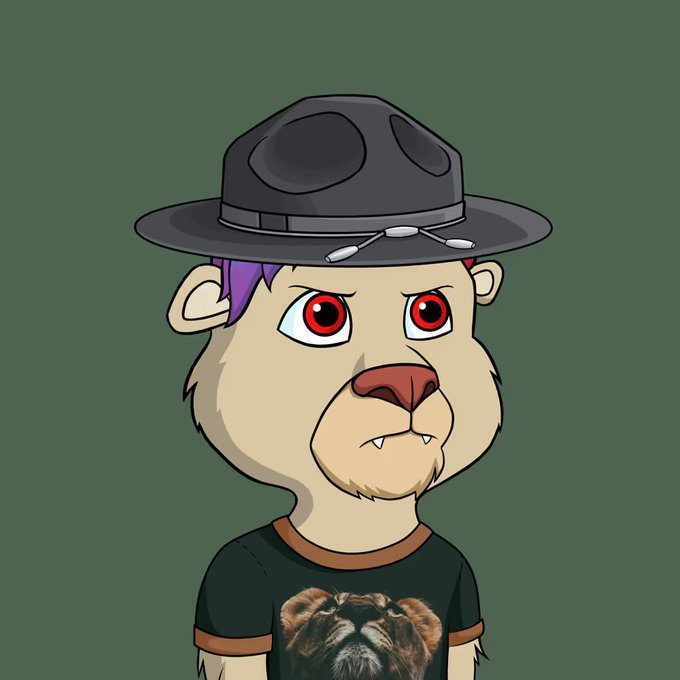 An anthropomorphic lion cub character wearing a black fedora with pins and a lion-graphic t-shirt, likely representing the "Lazy Lions" NFT collection mentioned in the post celebrating winning a cub from the @LazyLionsNFT community.