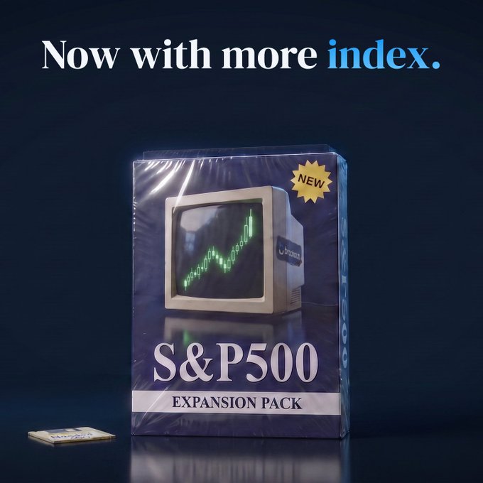 A sealed "S&P500 Expansion Pack" box wrapped in plastic with a "NEW" badge, featuring a retro computer monitor displaying a green candlestick chart and the headline "Now with more index." — humorously packaging the newly added TradFi asset on Breakout as if it were a vintage expansion card.