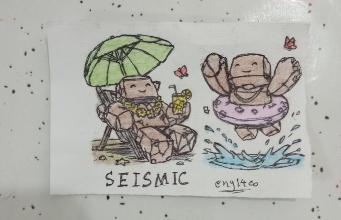 A hand-drawn illustration on fabric labeled 'SEISMIC' and signed 'enyltco' depicts two smiling stone-like characters—one lounging under a beach umbrella with a drink, and another splashing in a pool with an inner tube.