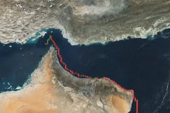 The image shows a satellite view of the Gulf of Oman/Horn of Africa region with the Strait of Hormuz highlighted by a red line, marking the critical maritime chokepoint through which roughly 20% of the world's oil passes.

The caption mocks Bitcoin's "supercycle" hype by suggesting that geopolitical crises in this volatile oil shipping region—where conflict can spike energy prices and trigger market panic—are the real "reality" investors face, making crypto gains pale in comparison to the sudden economic shocks that can crater risk assets regardless of bullish predictions.
