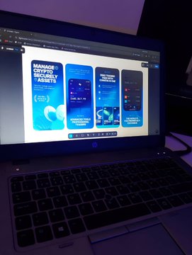 A laptop screen displays premium app store design mockups for a cryptocurrency application, with the leftmost screen prominently featuring the text "MANAGE CRYPTO SECURELY" and "30+ ASSETS" alongside a globe graphic. The other screens showcase additional interface designs for trading, building, and growing crypto holdings, aligning with the post's description of crypto app design screens.