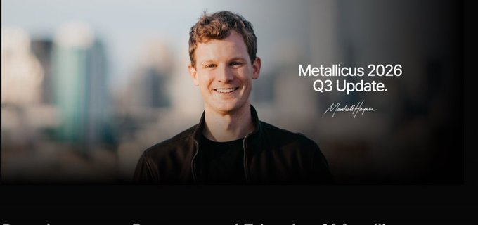 A smiling man in a black jacket stands against a blurred city skyline, with the text "Metallicus 2026 Q3 Update" and a signature beside him.