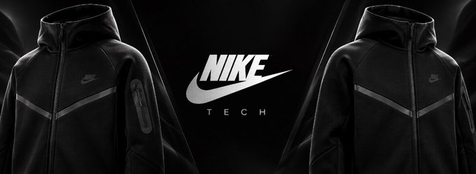 A promotional banner featuring a black Nike Tech hooded jacket displayed on both sides of the central white "NIKE TECH" logo and swoosh against a dark background.