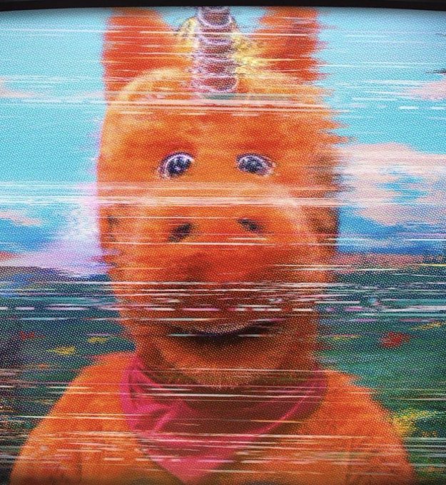 A distorted, glitchy photo of the Teletubbies character Po with VHS tracking lines running across the image.