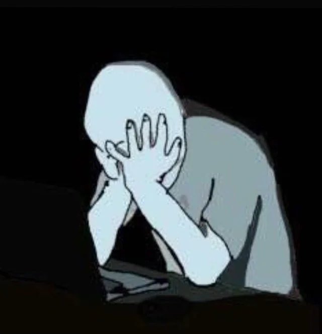 An animated figure with a pale, featureless head sits in darkness, holding their hand to their forehead in a gesture of despair or frustration.