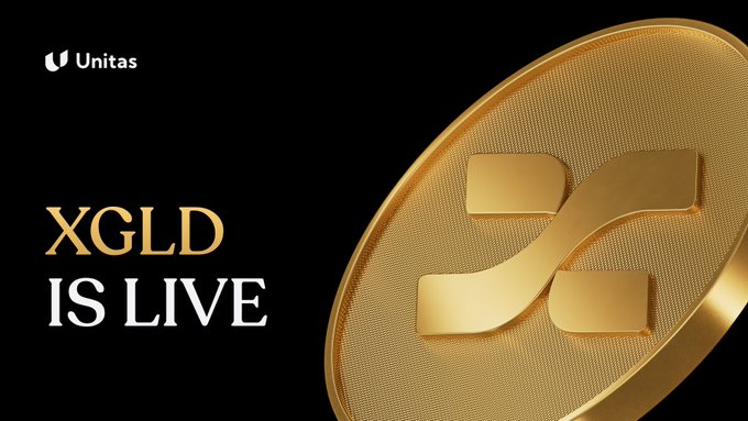The image features a gold coin with an X and Y symbol, which is the logo for the cryptocurrency XGLD. The text "XGLD IS LIVE" is displayed below the coin, indicating that the coin is currently active and available for trading.