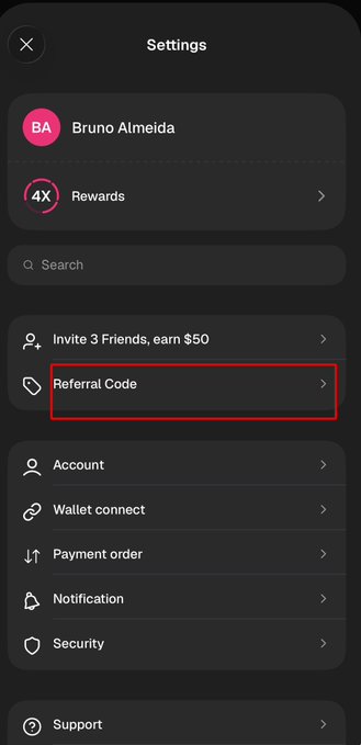 A mobile app settings screen displays a user profile for "Bruno Almeida" with a red box highlighting the "Referral Code" option among other menu items like "Account" and "Wallet connect."