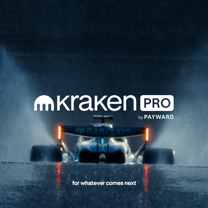 A race car drives through a rain-soaked track at night, with the "Kraken Pro by Payward" logo prominently displayed in the center and the tagline "for whatever comes next" below, alongside the Williams Racing "Barclays" branding on the car—visually reinforcing the high-performance, forward-driven partnership between Kraken Pro and Williams F1.