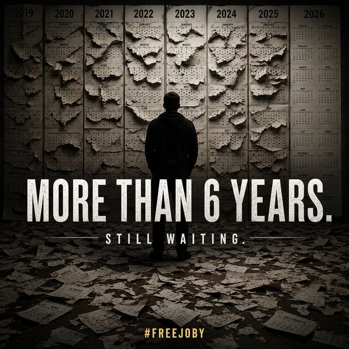 A dark, dramatic image showing a silhouetted figure standing before torn and weathered calendars from 2019 to 2026, with bold white text reading 'MORE THAN 6 YEARS. STILL WAITING.' and the hashtag '#FREEJOBY' at the bottom.