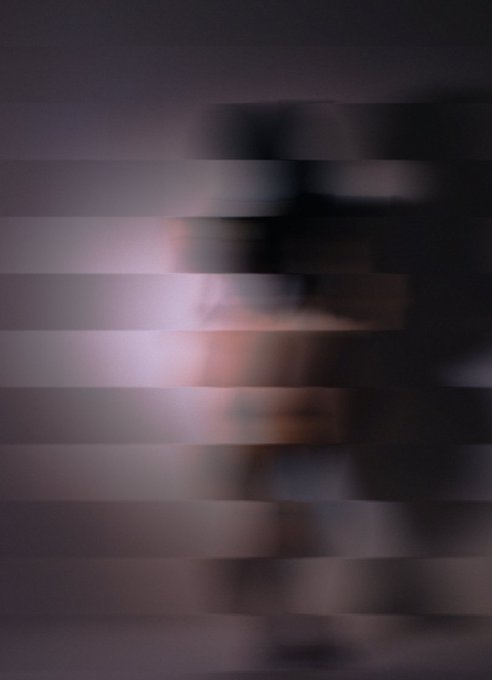 A heavily pixelated, blurry image showing horizontal bands of muted purple, pink, and dark tones, making the subject unidentifiable.