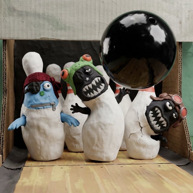 Clay figurines of zombie characters, including one with a red bandana and another with green goggles, gathered around a large black bowling ball.