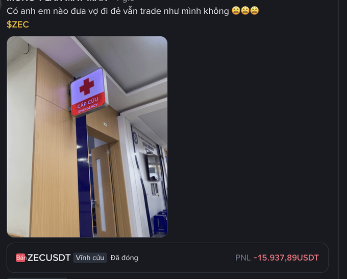 A social media post showing a hospital emergency entrance with a 'CẤP CỨU EMERGENCY' sign, accompanied by Vietnamese text about trading ZEC and showing a trading position closed at a loss with PNL -15.937,89USDT.