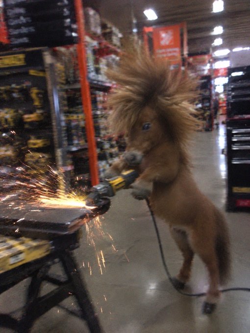 A pony standing on its hind legs uses an angle grinder on a metal workbench, sending sparks flying in what appears to be a hardware store aisle.