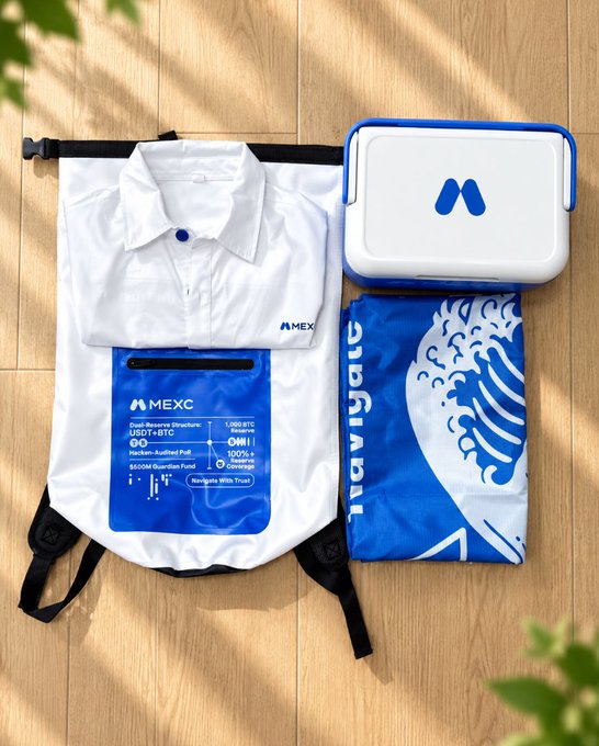 A promotional display of MEXC cryptocurrency exchange merchandise including a white polo shirt, a branded bag, a white cooler, and a blue t-shirt laid out on a wooden floor.