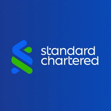 The image shows the Standard Chartered bank logo, displayed in white and green on a blue background. It represents the financial institution mentioned in the post, which partnered with Ripple to facilitate fast international payments using its network across Asia, Africa, and the Middle East.