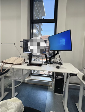 The image shows a desk with two computer monitors placed side by side, along with a keyboard and mouse. The desk also has a white bag sitting next to it. In the background, there's a window that provides natural light into the room. A person is visible in the scene, possibly working or studying at the desk.

The image is related to the post because it features an advertisement for a trading bot developed by a student named Claude. The bot specializes in short-term BTC up/down markets and has made $193,000 on Polymarket. It uses limit orders for execution, blending arbitrage, market-making, and hedging strategies into one.