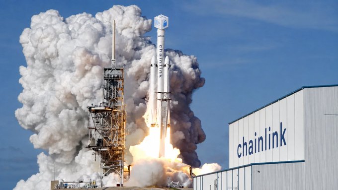 A rocket launches through billowing smoke with the word "chainlink" visible on both the rocket itself and on a large building to the right, visually representing the post's "$LINK has lift off" message by depicting the Chainlink cryptocurrency as a rocket blasting off into the sky.