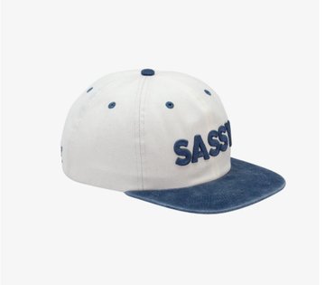 A white and blue baseball cap with 'SASQUATCH' embroidered in blue lettering on the side and front.