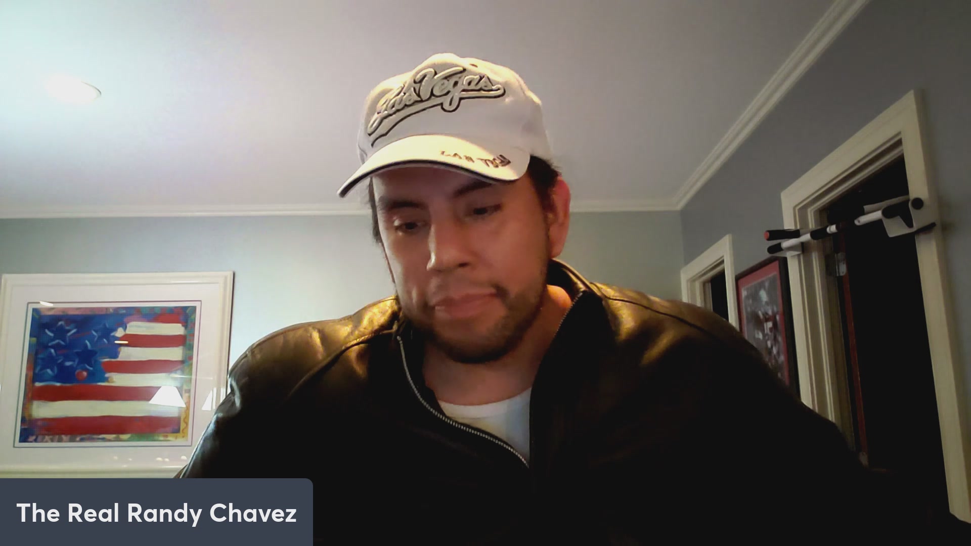 The image shows a man wearing a white baseball cap sitting down, possibly working at his computer or looking at something else that has caught his attention. The caption of the image reads "VeVe grosses 820k in May! 1.1k new users in 2 weeks! $OMI Dacat and Loki talk!". This suggests that there might be a popular video or content related to the baseball cap, possibly featuring the man wearing it, which has attracted many viewers.
