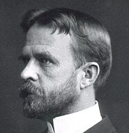 A black-and-white portrait photograph shows a bearded man in profile with a serious expression, likely Thomas Hunt Morgan, the Nobel Prize-winning geneticist famous for his pioneering fruit fly (Drosophila) research. The image aligns with the post's caption about Morgan's transformative contributions to genetics and his Nobel Prize recognition.
