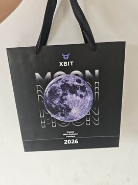 A black gift bag from 'XBIT' featuring a moon graphic and 'HAPPY MID-AUTUMN FESTIVAL 2026' text.