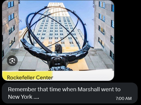 A photo card of the Atlas statue at Rockefeller Center with a caption reading 'Remember that time when Marshall went to New York...' timestamped 7:00 AM.