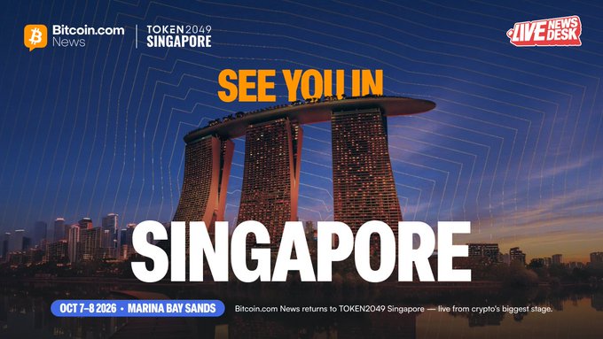 A promotional graphic announces "SEE YOU IN SINGAPORE" for the TOKEN2049 conference at Marina Bay Sands on October 7-8, 2026, featuring the iconic Singapore skyline and Marina Bay Sands hotel against a blue gradient background, with Bitcoin.com News and Live News Desk logos in the top corners and additional details noting Bitcoin.com News will provide live coverage from crypto's biggest stage.