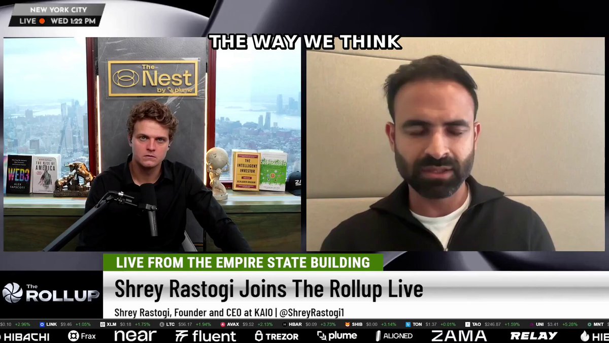 The image shows a man sitting at a desk with a microphone, likely recording an interview or podcast. The background of the image features a city skyline, suggesting that they are taking place in New York City. The text on the screen reads "The way we think", which is likely related to the topic being discussed during the interview.