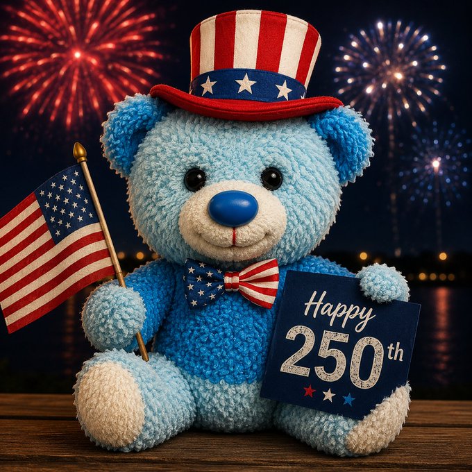 A blue Care Bear plush wearing an Uncle Sam-style top hat and stars-and-stripes bow tie, holding an American flag and a 'Happy 250th' sign, set against a fireworks background.
