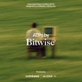 A muted promotional poster for the film 'Adoptee' by Bitwise showing two figures sitting on a bench in a green field, with credits text at top and festival laurels at bottom.