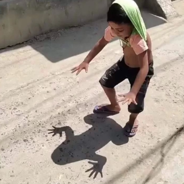 A boy crouches on a dirt street, reaching toward the shadow his outstretched hands cast on the ground—a playful metaphor for grasping at something illusory. The image mirrors the post's critique: chasing "trustless" crypto ideals only to find yourself shadowboxing with your own email and wallet popups instead of real decentralization.