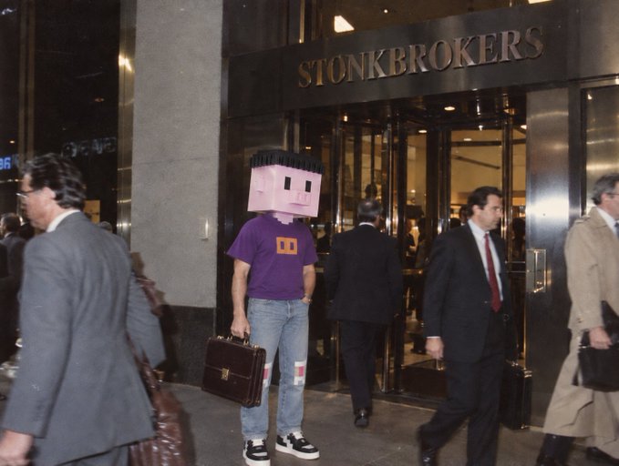 A retro-styled photo of a person wearing a pink cubic helmet and a purple shirt with an orange logo, holding a briefcase while standing on a city street in front of a building labeled 'STONKBROKERS'.