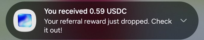 The image shows a message box with a purple background, displaying a message that reads "You received 0.59 USDC from @baseapp as ref reward. I have over 90 referrals on Baseapp." The text indicates that the user has been rewarded for their referrals and is being credited with 0.59 USDC.