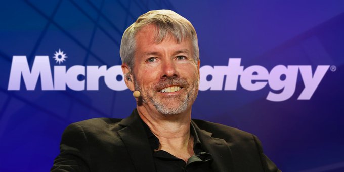 Michael Saylor is featured prominently in the image, sitting behind a podium with his hands on his lap. The background features a blue banner that reads "MicroStrategy", which suggests that Michael Saylor might be discussing or promoting strategies related to microstrategy. The image also includes text that says "focus on what is in the image and how it relates to the post". This implies that the main focus of the image should be on Michael Saylor, his role as a strategy expert, and possibly his recent sale of Bitcoin.