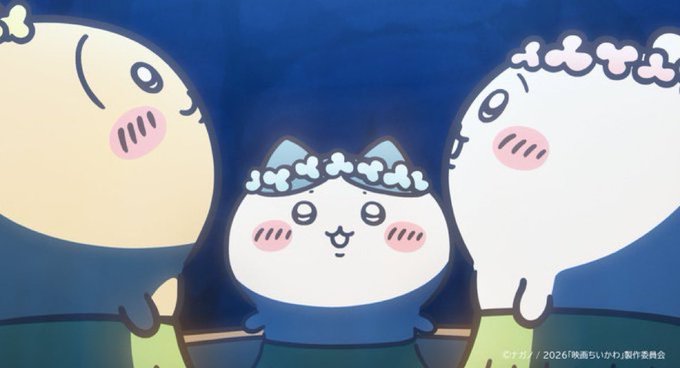 Three Chiikawa characters—a cream-colored round figure on the left, a white cat with a blue floral headband in the center, and another white character with a floral crown on the right—stand together against a dark blue background with the Japanese copyright text "©ナガノ / 2026「映画ちいかわ」製作委員会" visible in the corner, capturing the adorable and memeable aesthetic driving the franchise's viral surge.
