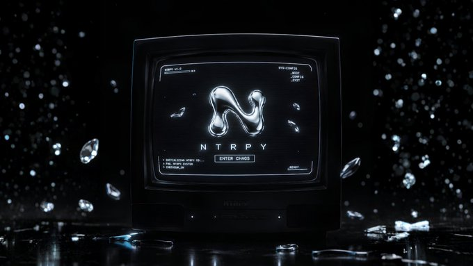 A retro CRT television displaying a metallic liquid chrome "N" logo with "NTRPY" text and "ENTER CHAOS" prompt, set against a dark background with floating crystal/diamond fragments.