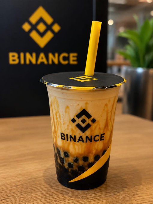 This image shows a bubble tea with the Binance logo and name displayed prominently. The drink is a sweet, creamy beverage topped with a yellow straw, mirroring the "cruising nicely" theme of the post.