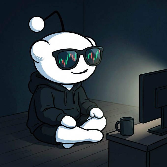 A cartoon white character with an antenna wears sunglasses reflecting stock market charts and sits cross-legged on a desk next to a monitor and coffee mug.