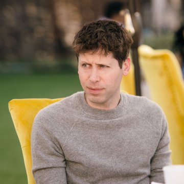A man in a gray sweater sits in a yellow chair, with the caption noting that Sam Altman warned that AI is on the verge of transforming the landscape of cyber attacks.